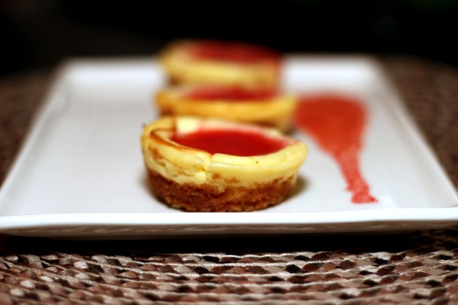 mini personal cheesecake with strawberry sauce